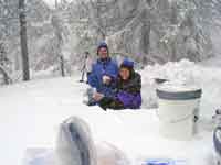 Workers collect snow sample at Apgar Lookout sampling site, Montana.