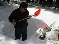 Worker makes measurements in snowpit near University Camp, Colo.