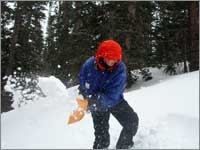 Worker prepares snowpack-sampling pit at Loch Vale Forest, Colo.