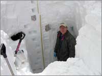 Worker in snowpack-sampling pit at Old Battle, Wyo.