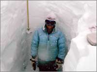 Worker in snowpack-sampling pit at Rendezvous Mountain, Wyo.