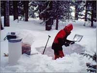 Worker prepares snowpack-sampling pit at Twenty-One Mile, Mont.